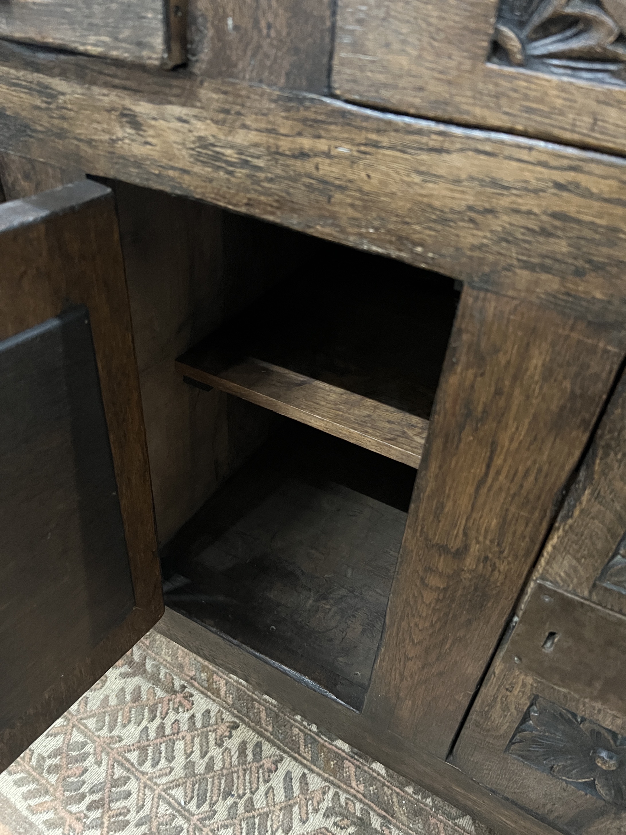 A 17th century style “Tudor Furniture” carved oak dresser, width 146cm, depth 53cm, height 168cm